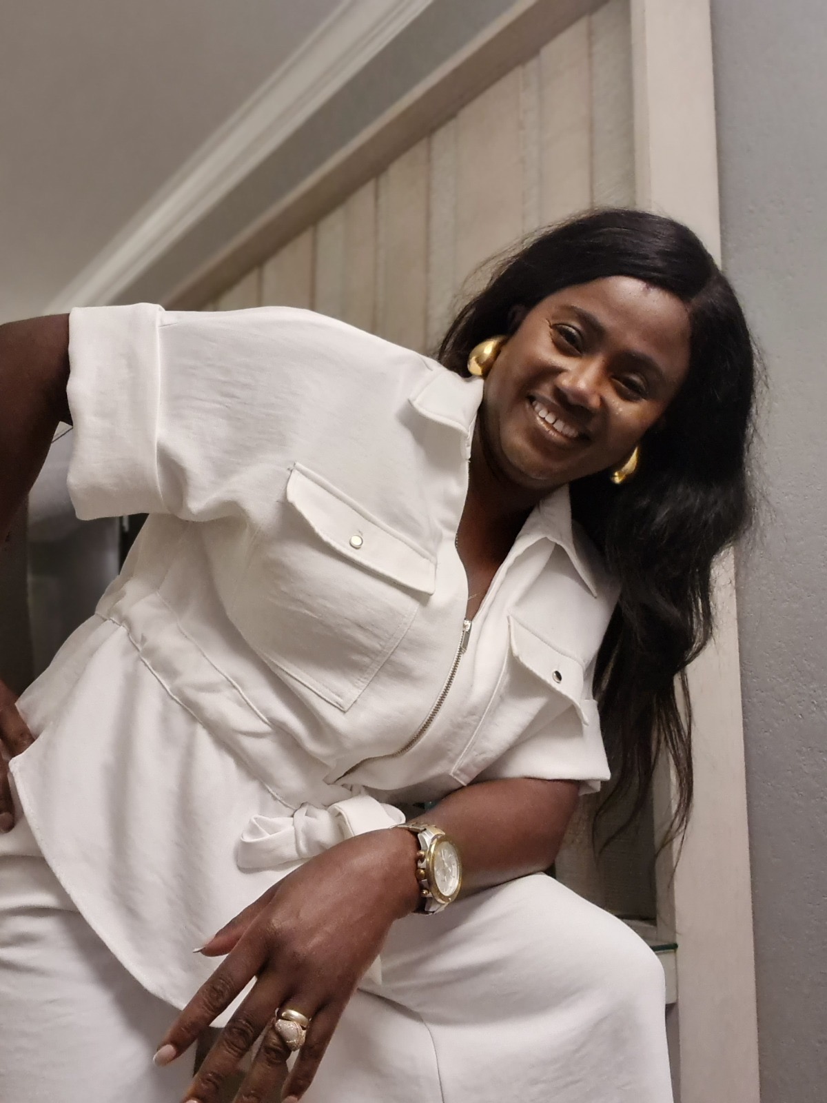 Kemi Areola smiling in a white outfit